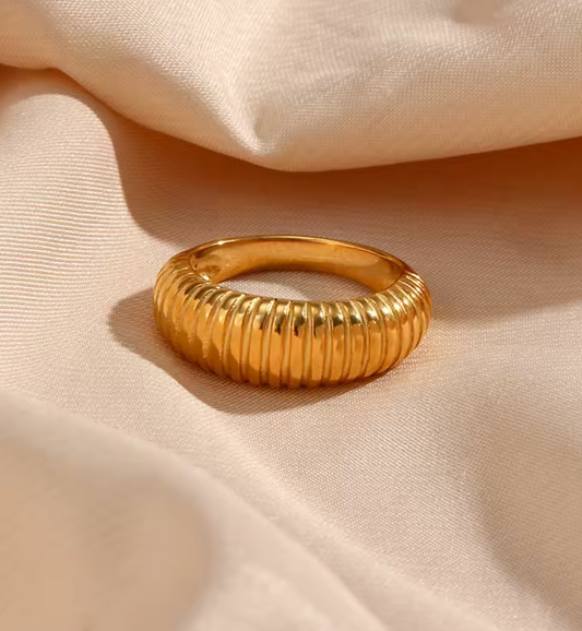 Gold ring on a beige fabric background