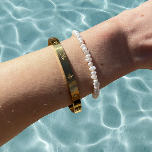 stacking gold bangle and pearl bracelet