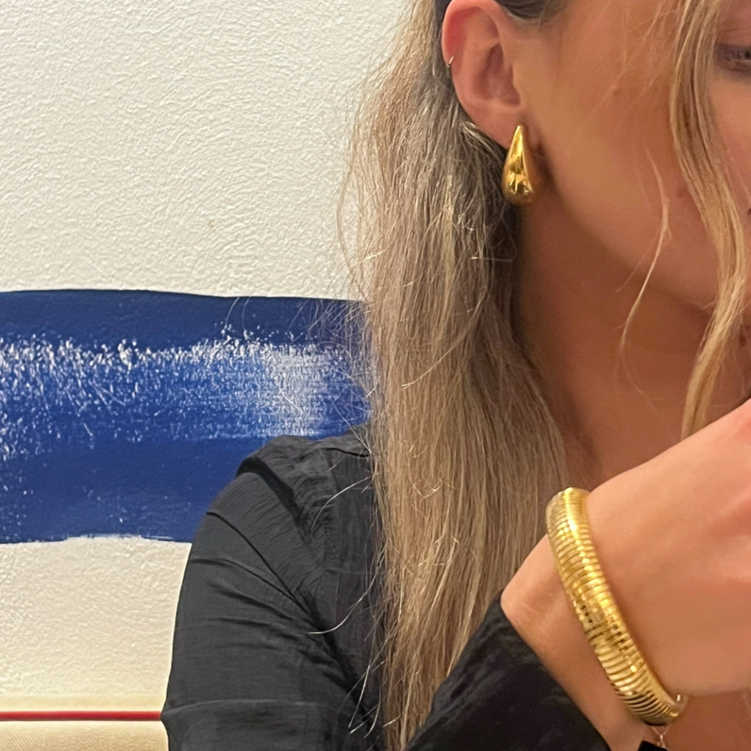 girl wearing gold waterproof bangle