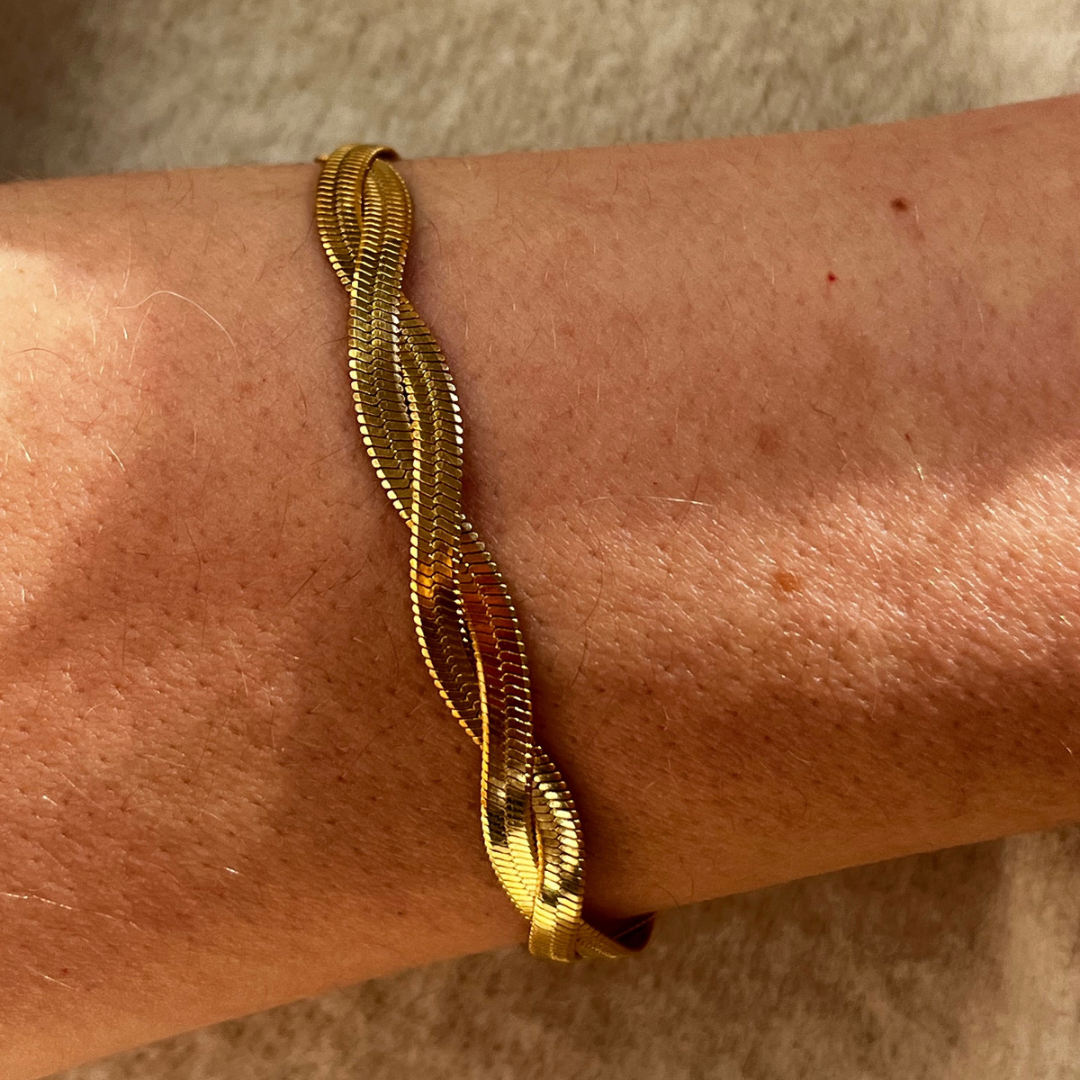 Twisted gold bracelet on arm