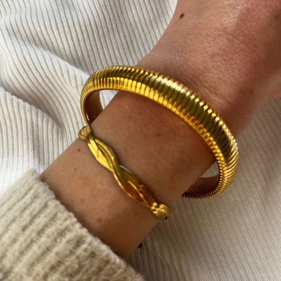 Gold bangles on wrist 