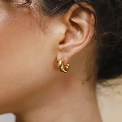 Girl wearing gold hoop earring 